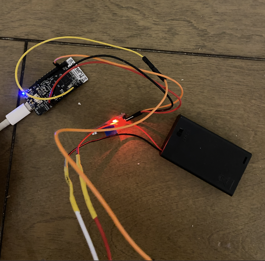 The ESP32 connected via wires to the microphone. The wires that connect the LED strip to the battery pack and to the ESP32 are visible, but the LED strip itself is not.